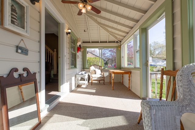 sunroom / solarium with vaulted ceiling with beams and ceiling fan