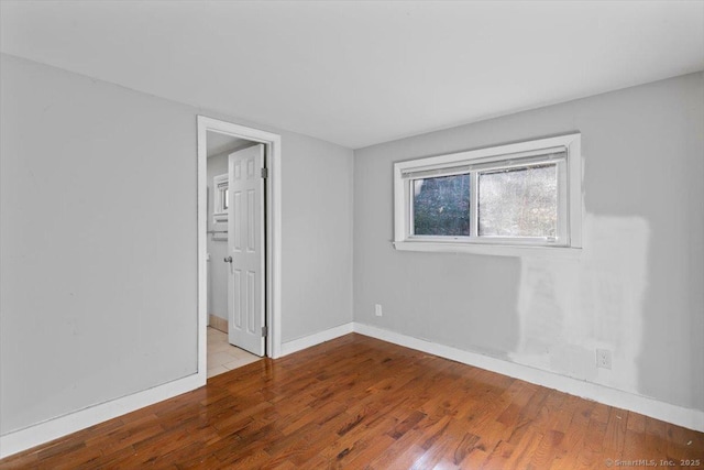 empty room with hardwood / wood-style flooring