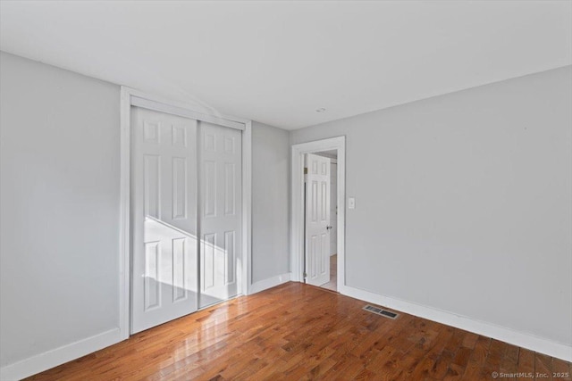 unfurnished room with wood-type flooring