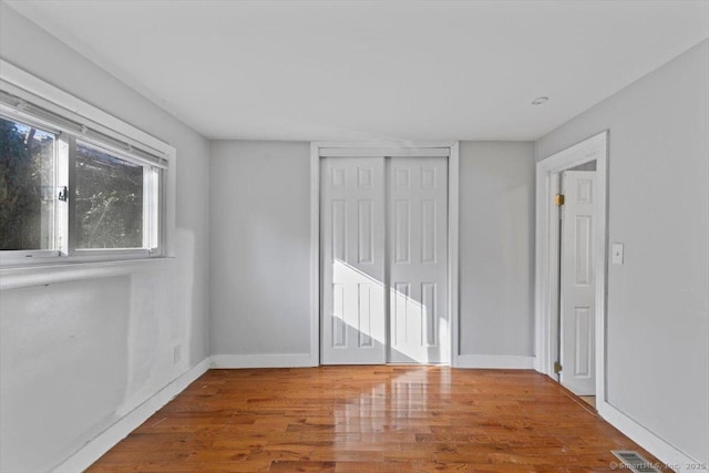 unfurnished room with hardwood / wood-style floors