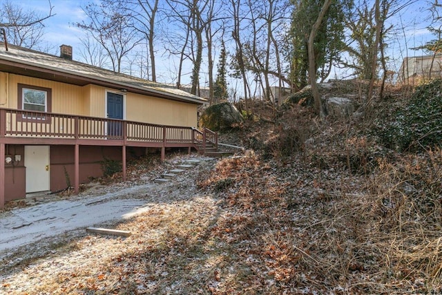 view of property exterior featuring a deck