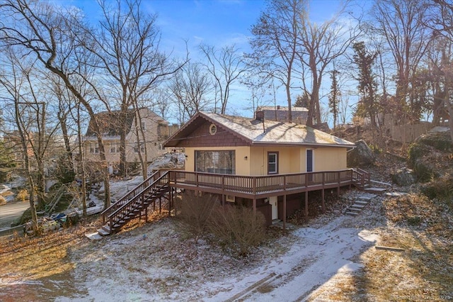 back of house with a deck