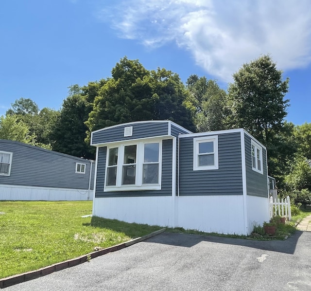 view of home's exterior with a yard