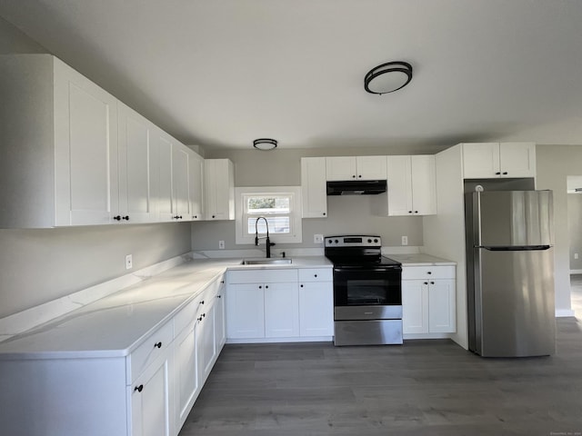 kitchen featuring white cabinetry, sink, stainless steel appliances, and dark hardwood / wood-style floors