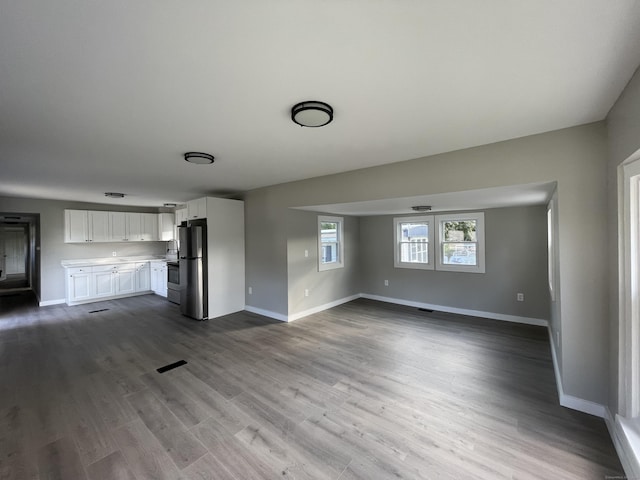 unfurnished living room with wood-type flooring