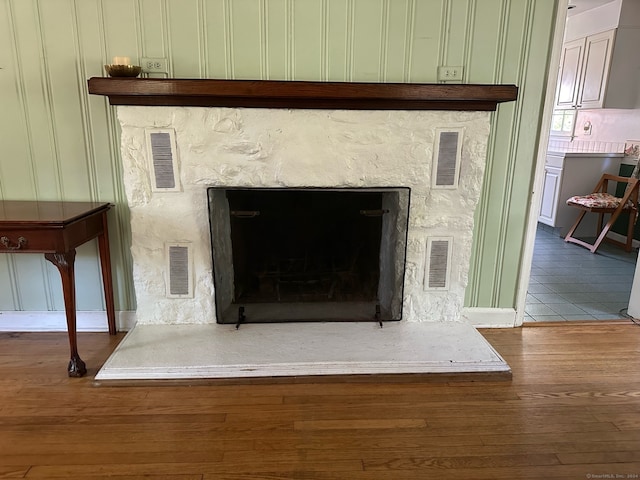 interior details with hardwood / wood-style floors and a high end fireplace