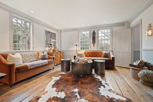 living room with light hardwood / wood-style flooring and ornamental molding