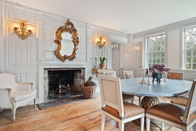 155 Joshuatown Rd, Lyme, CT 06371 - dining space featuring hardwood / wood-style flooring, a chandelier, a fireplace, and ornamental molding