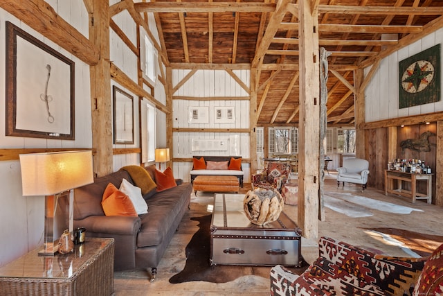 interior space with beam ceiling, wood walls, and high vaulted ceiling