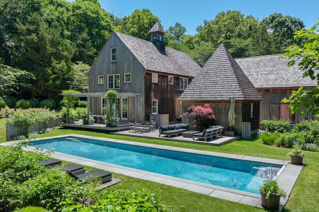 rear view of house with an outbuilding, a yard, an outdoor hangout area, and a patio area