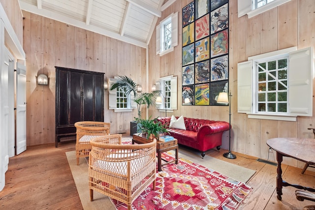 155 Joshuatown Rd, Lyme, CT 06371 - living area with wood walls, wood-type flooring, high vaulted ceiling, plenty of natural light, and a wooden ceiling with exposed beams
