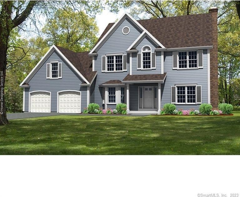 colonial-style house with a front yard, driveway, and a chimney