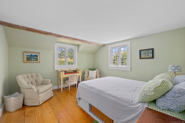 bedroom with multiple windows, light hardwood / wood-style flooring, and lofted ceiling