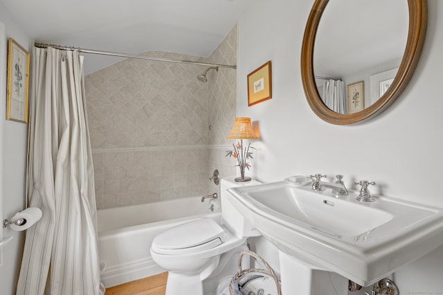 full bathroom with toilet, shower / tub combo, sink, and hardwood / wood-style floors