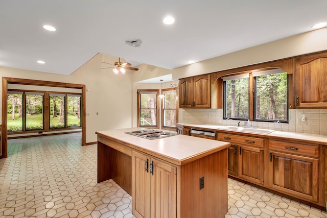 kitchen featuring backsplash, dishwasher, stainless steel gas stovetop, and a kitchen island