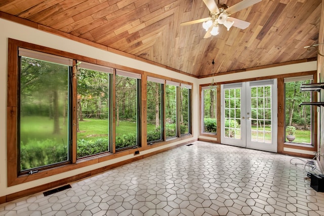 unfurnished sunroom with a healthy amount of sunlight, wood ceiling, and french doors