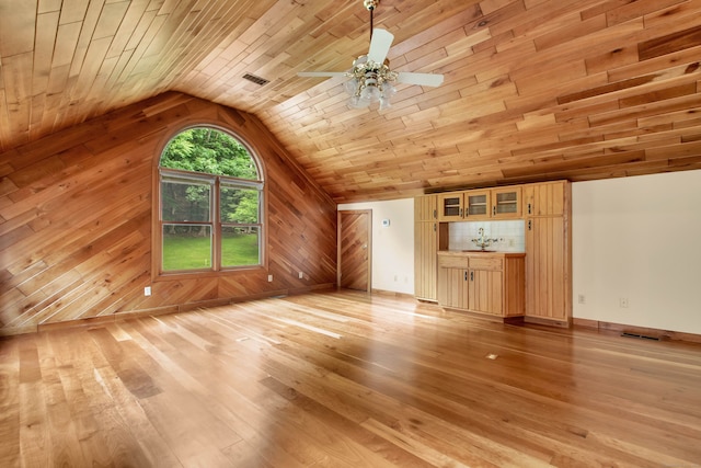 bonus room with wood walls, vaulted ceiling, wooden ceiling, and light hardwood / wood-style flooring