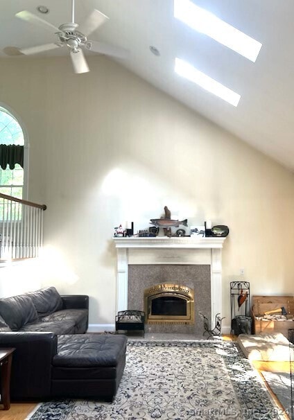 46 Nedobity Rd, Haddam, CT 06441 - living room featuring high vaulted ceiling, a ceiling fan, a fireplace with flush hearth, wood finished floors, and baseboards