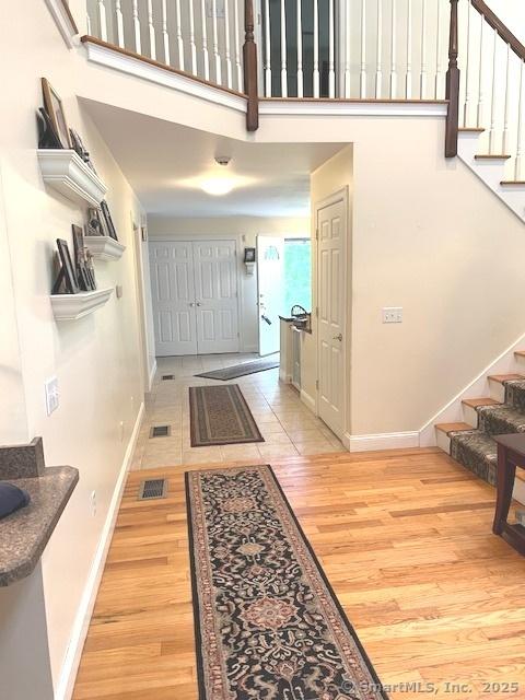 46 Nedobity Rd, Haddam, CT 06441 - entrance foyer with stairs, baseboards, light wood-type flooring, and a high ceiling