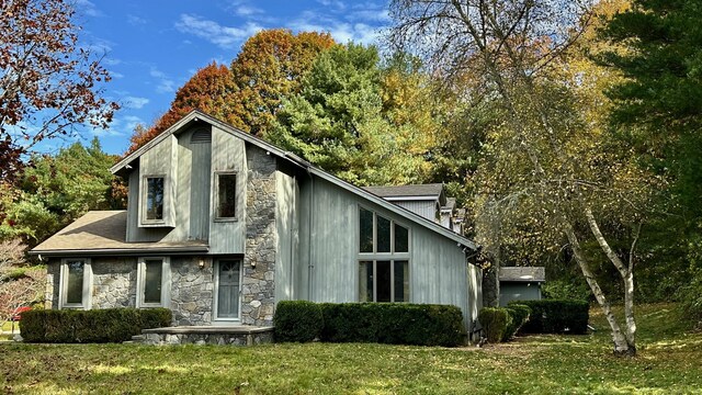 view of property exterior with a lawn