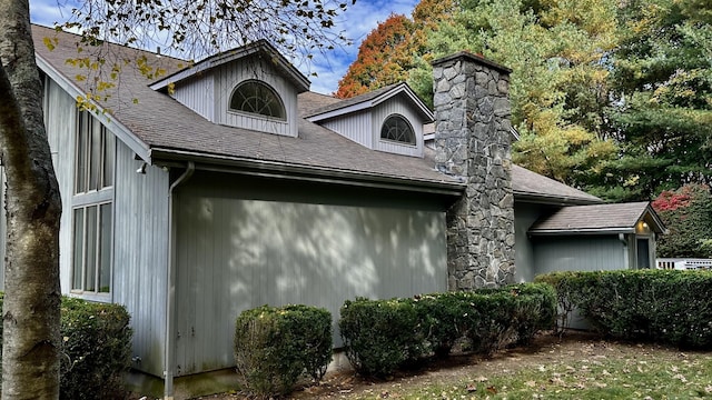 162 Pequot Trl, Stonington, CT 06379 - view of side of home featuring a chimney and a shingled roof