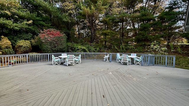 wooden terrace featuring outdoor dining area