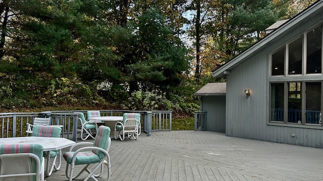 wooden terrace featuring outdoor dining area