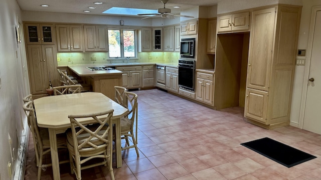 kitchen with glass insert cabinets, light countertops, decorative backsplash, black appliances, and a ceiling fan