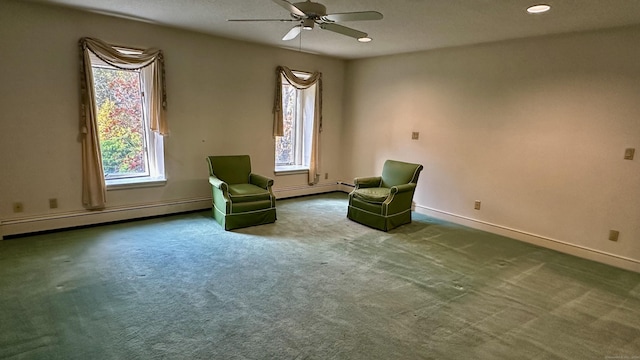 unfurnished room with a wealth of natural light, a baseboard heating unit, carpet floors, and baseboards