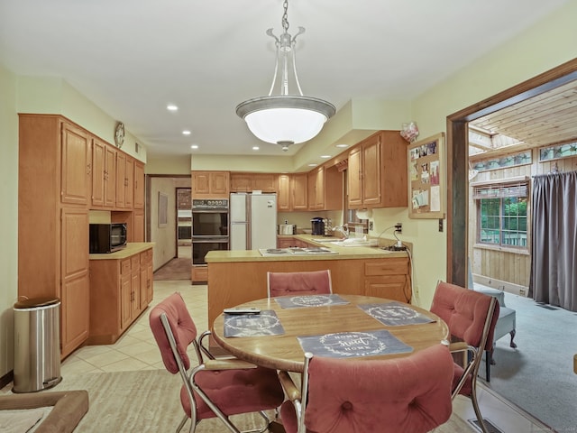 dining room with sink and light tile patterned flooring