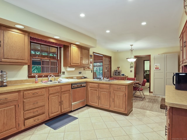 kitchen with pendant lighting, stainless steel gas cooktop, dishwasher, kitchen peninsula, and sink