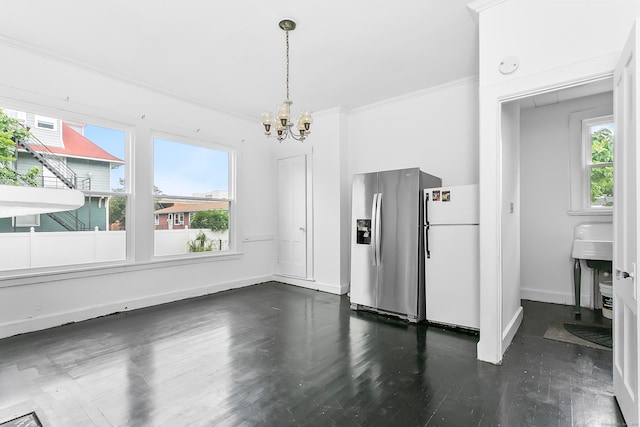 unfurnished dining area with an inviting chandelier, hardwood / wood-style flooring, and a healthy amount of sunlight