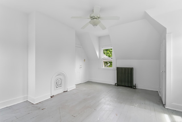 bonus room with ceiling fan, lofted ceiling, hardwood / wood-style floors, and radiator heating unit