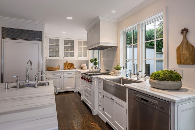 kitchen featuring white cabinetry, tasteful backsplash, dishwasher, dark wood-type flooring, and paneled built in refrigerator