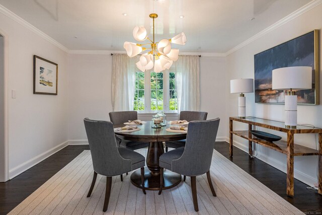 dining area with dark wood-type flooring, a chandelier, and ornamental molding