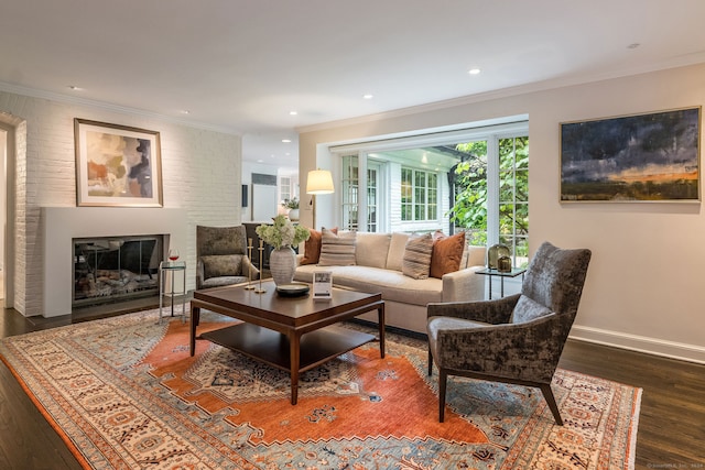 living room featuring brick wall, dark hardwood / wood-style flooring, and ornamental molding