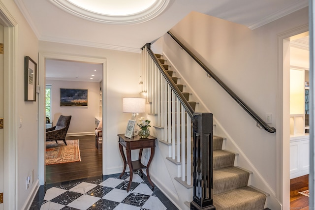 staircase with crown molding and dark tile patterned flooring