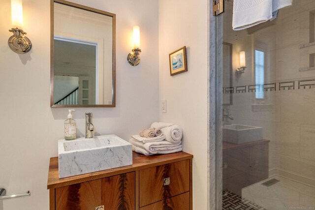 bathroom with vanity and a tile shower