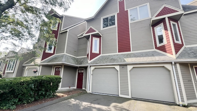 townhome / multi-family property featuring a garage