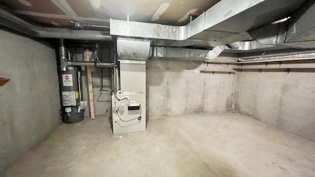 basement featuring gas water heater and heating unit