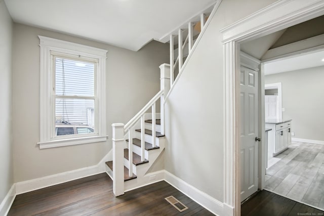 stairway featuring wood-type flooring