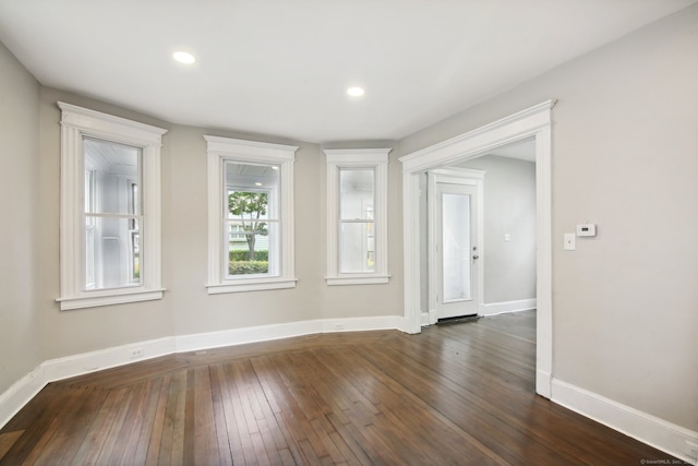 spare room featuring dark hardwood / wood-style floors