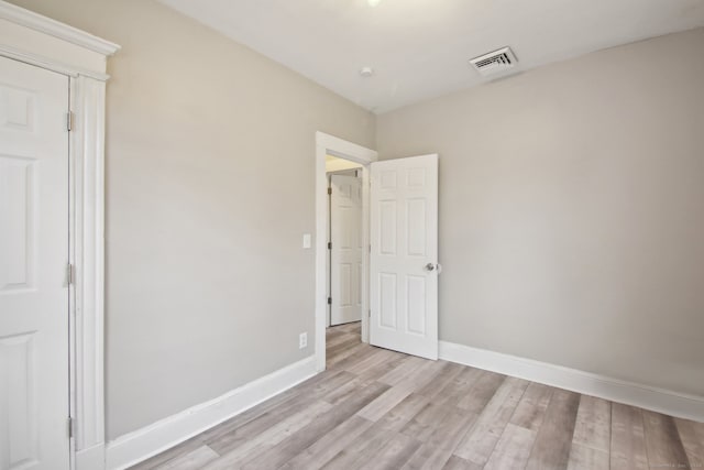 unfurnished bedroom with light wood-type flooring