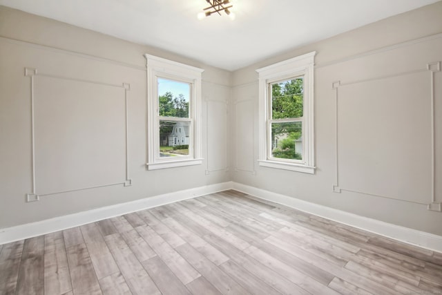 spare room featuring light hardwood / wood-style flooring