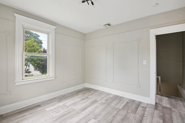 unfurnished room featuring light hardwood / wood-style floors