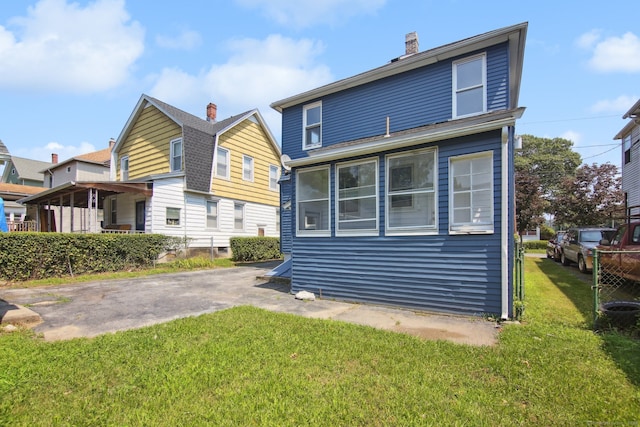 back of property featuring a lawn