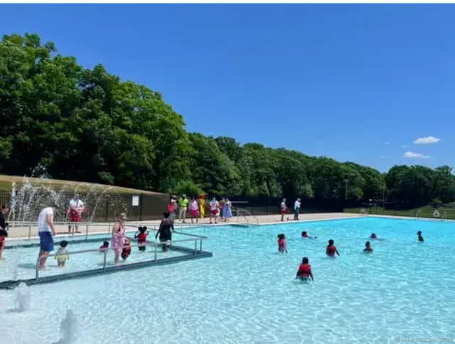 view of swimming pool featuring pool water feature