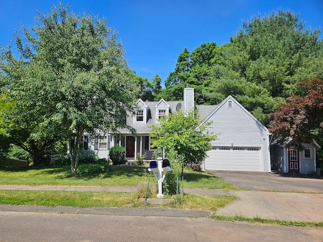 view of front of house featuring a garage and a front lawn