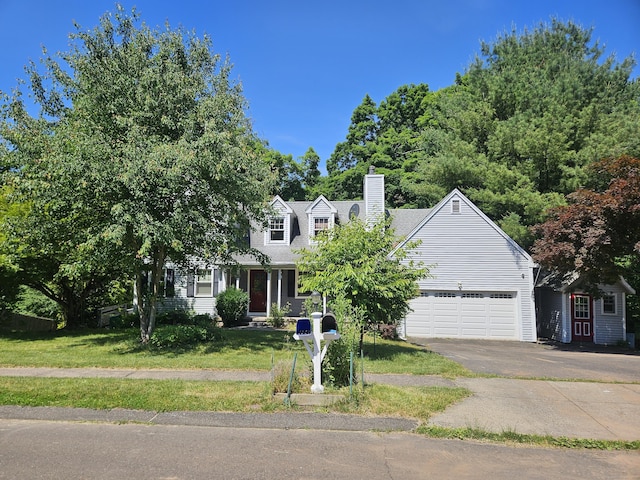 cape cod house featuring a front lawn and a garage