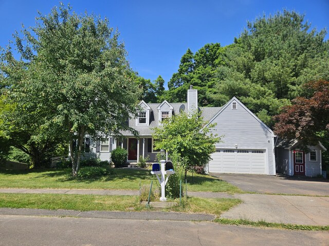 view of front facade with a garage and a front lawn